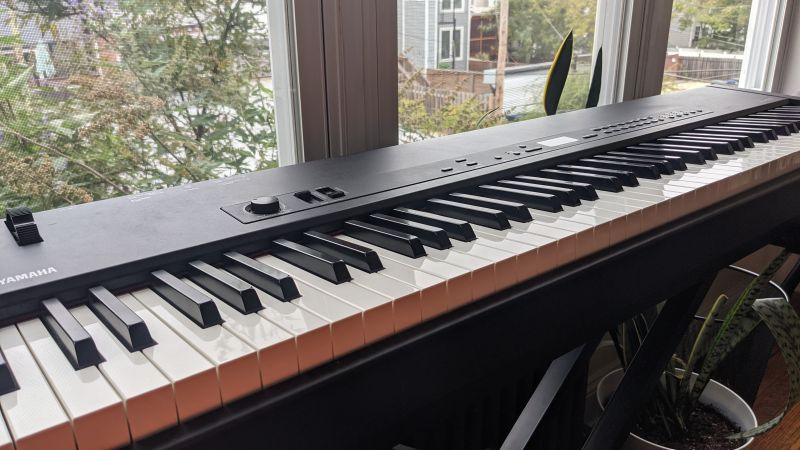 Yamaha CP-33 keyboard overlooking a window